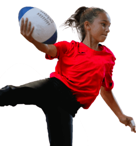 Young girl with rugby ball in action