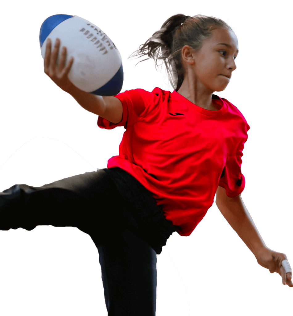 Young girl with rugby ball in action